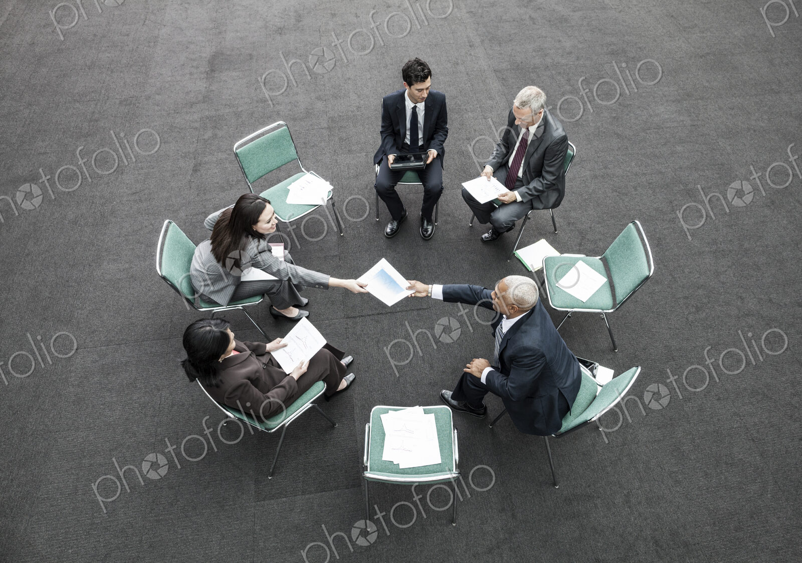 Mixed race group of business people in an informal team building meeting.