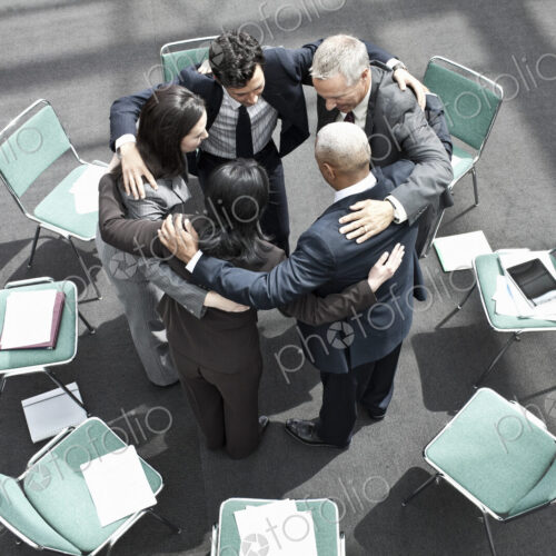 Mixed race group of business people in an informal team building meeting. Mixed race group of business people in an informal team building meeting.