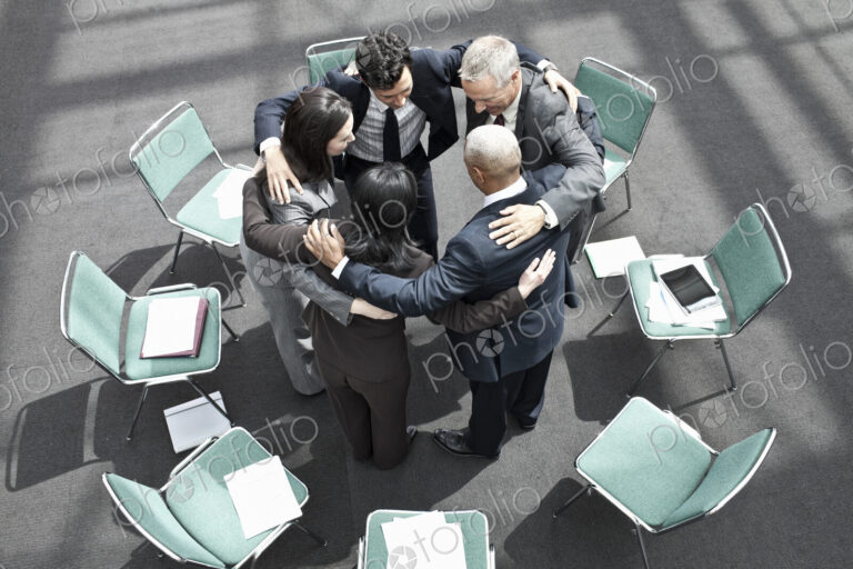 Mixed race group of business people in an informal team building meeting.