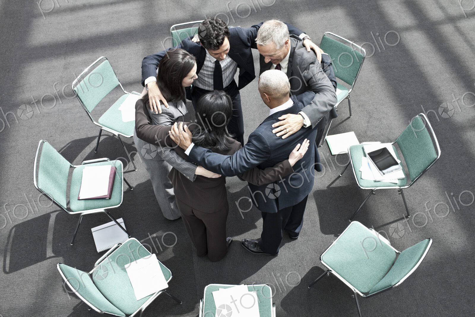 Mixed race group of business people in an informal team building meeting.