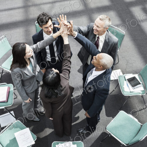 Mixed race group of business people in an informal team building meeting. Mixed race group of business people in an informal team building meeting.
