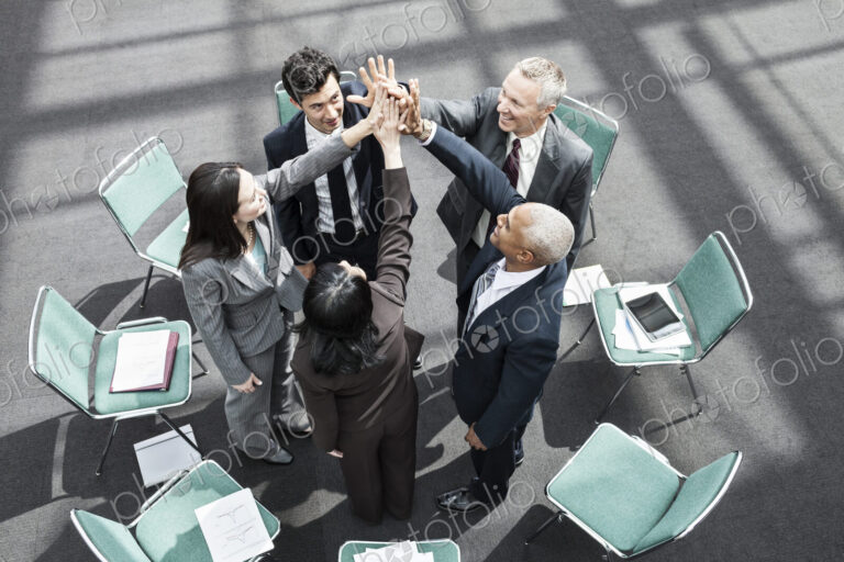 Mixed race group of business people in an informal team building meeting.