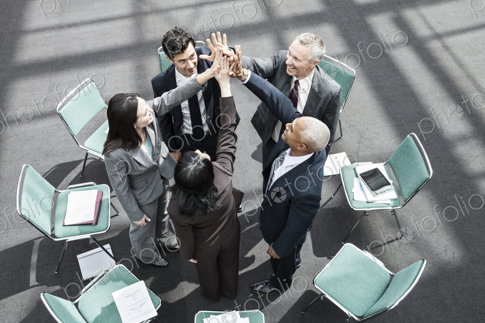 Mixed race group of business people in an informal team building meeting.