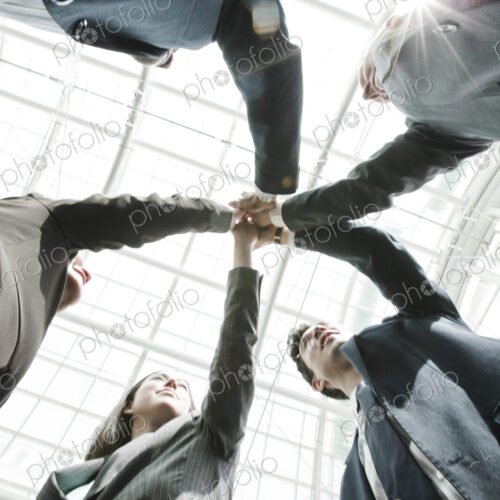 Mixed race group of business people standing in a team building circle. Mixed race group of business people standing in a team building circle.