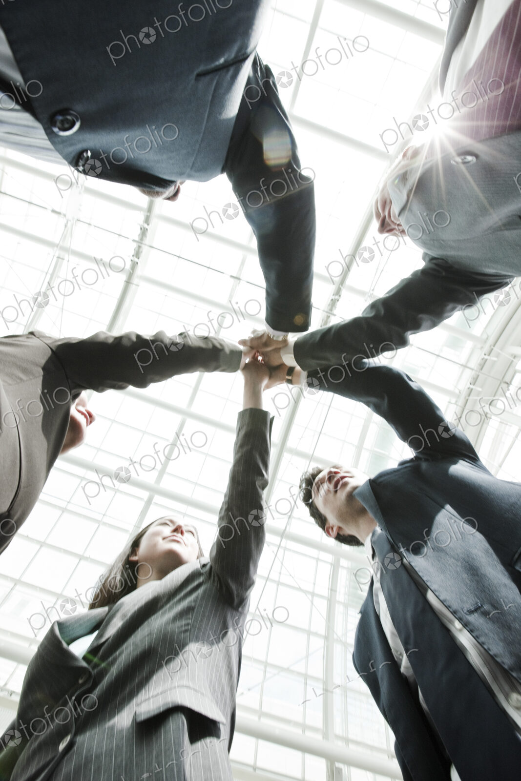 Mixed race group of business people standing in a team building circle.