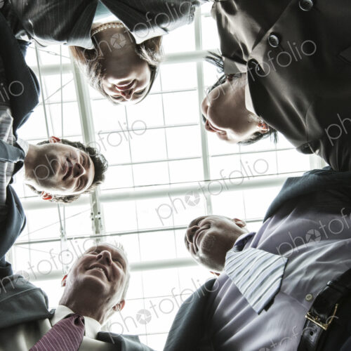 Mixed race group of business people standing in a team building circle. Mixed race group of business people standing in a team building circle.