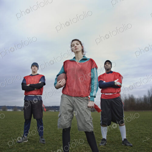 Mixed race members of a team of American football players.