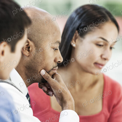 Mixed race team of business people at a table in a business center.