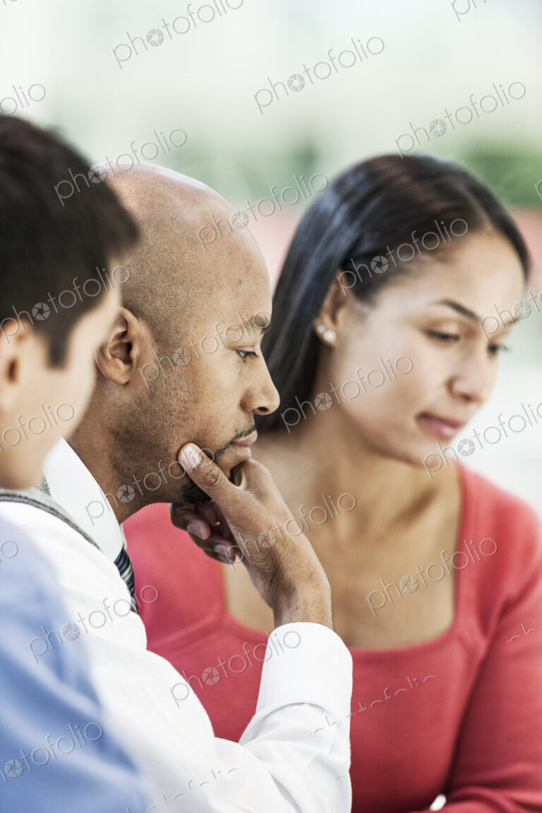 Mixed race team of business people at a table in a business center.