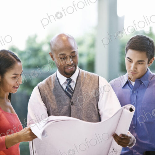 Mixed race team of business people at a table in a business center. Mixed race team of business people at a table in a business center.