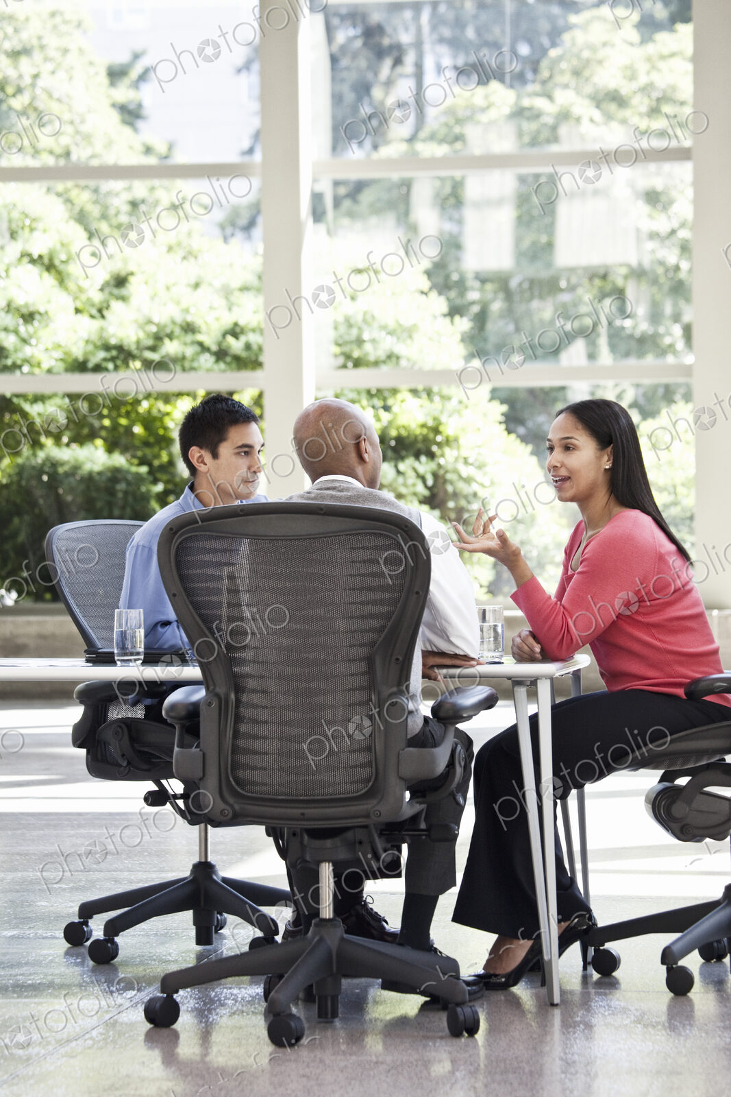 Mixed race team of business people at a table in a business center.