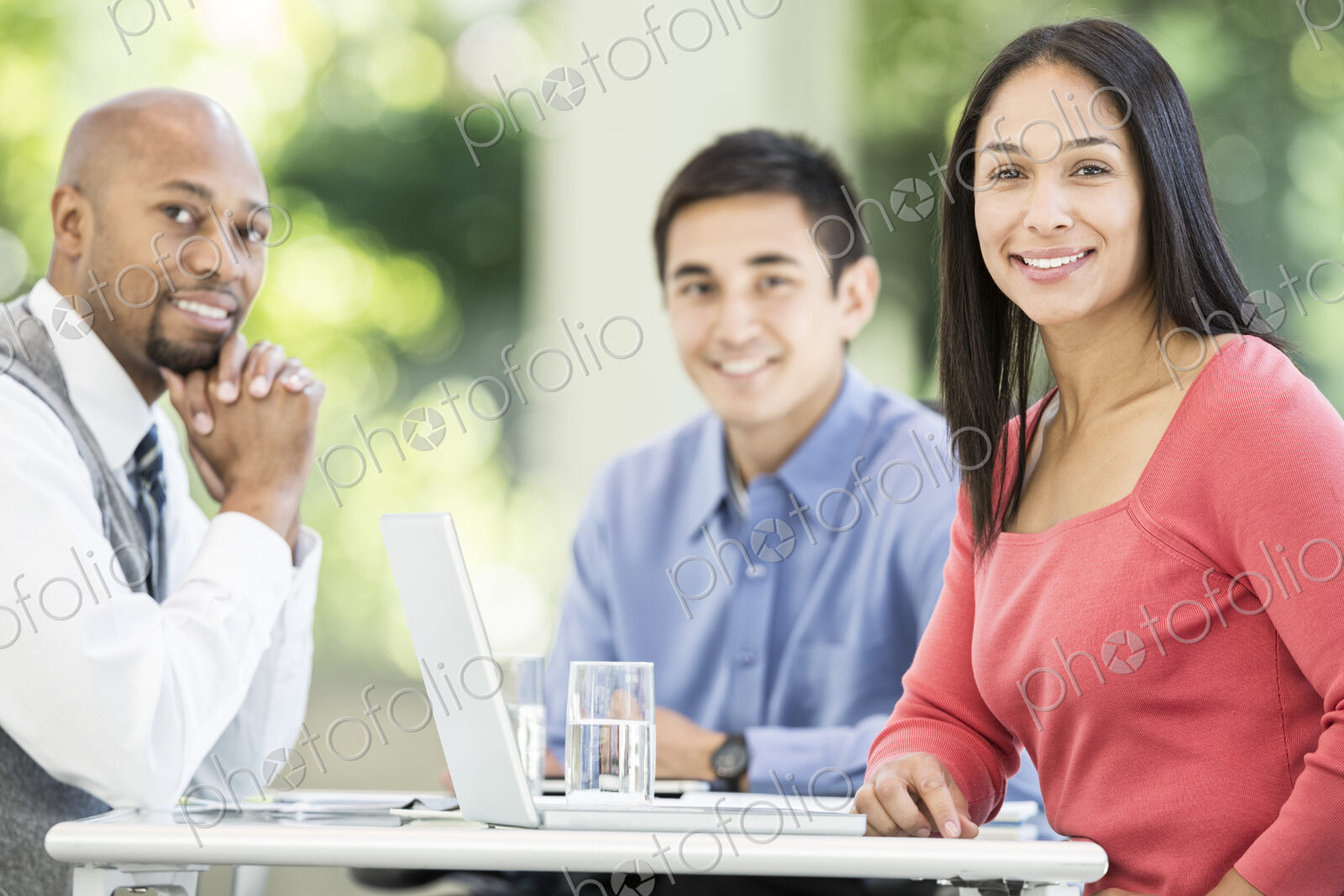 Mixed race team of business people at a table in a business center.