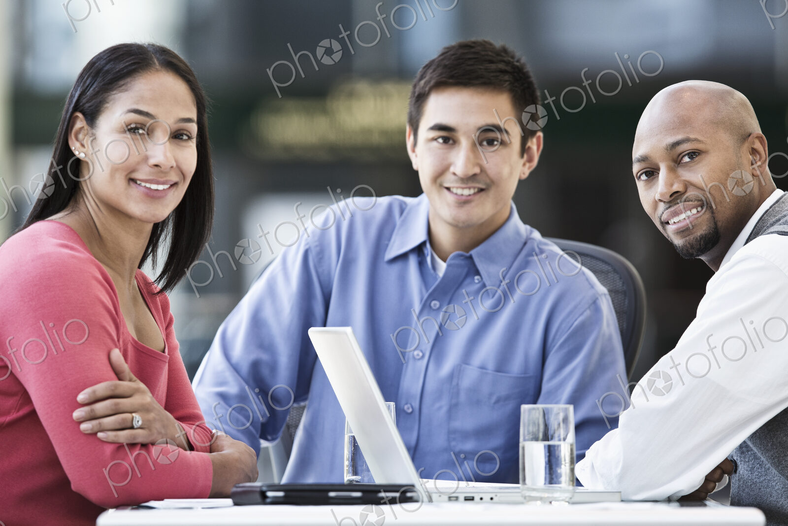 Mixed race team of business people at a table in a business center.