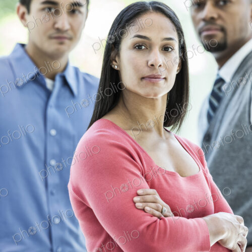 Mixed race team of business people at a table in a business center. Mixed race team of business people at a table in a business center.