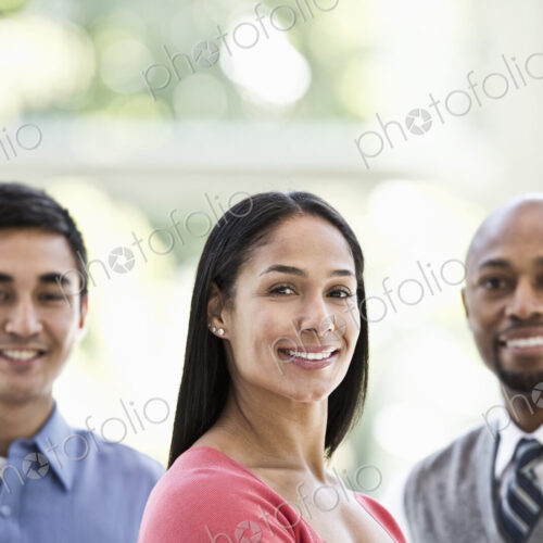 Mixed race team of business people at a table in a business center. Mixed race team of business people at a table in a business center.