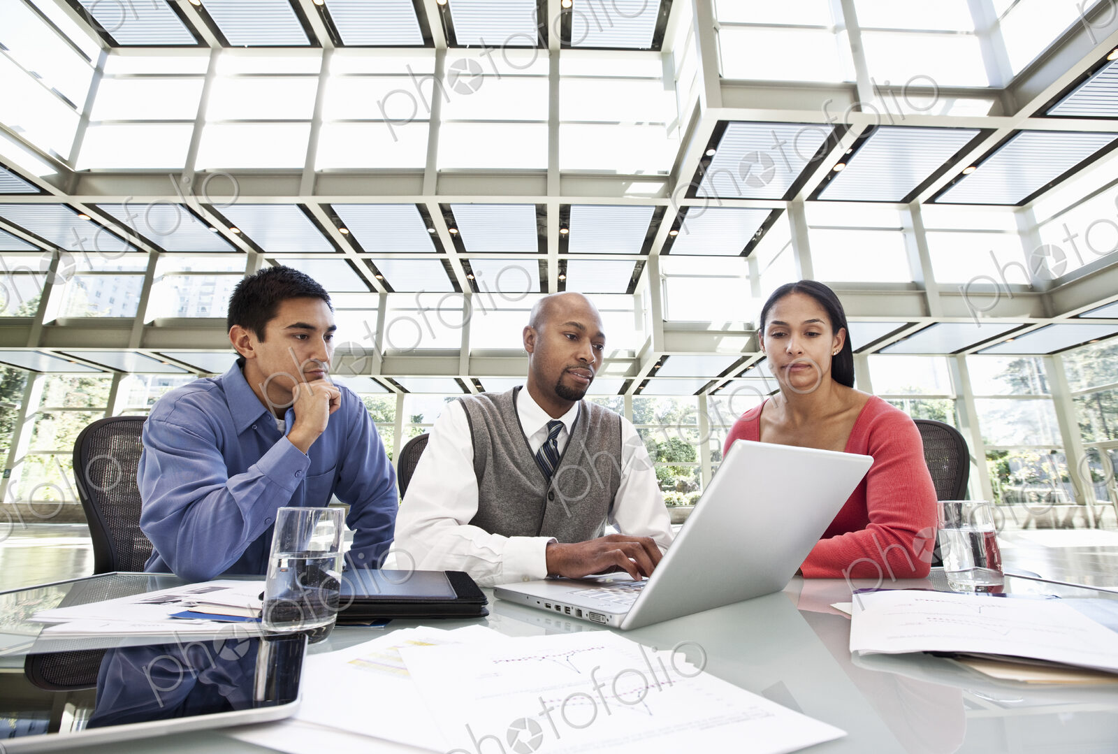 Mixed race team of business people at a table in a business center.