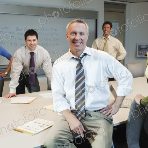 Mixed race team of business people in a conference room setting. Mixed race team of business people in a conference room setting.