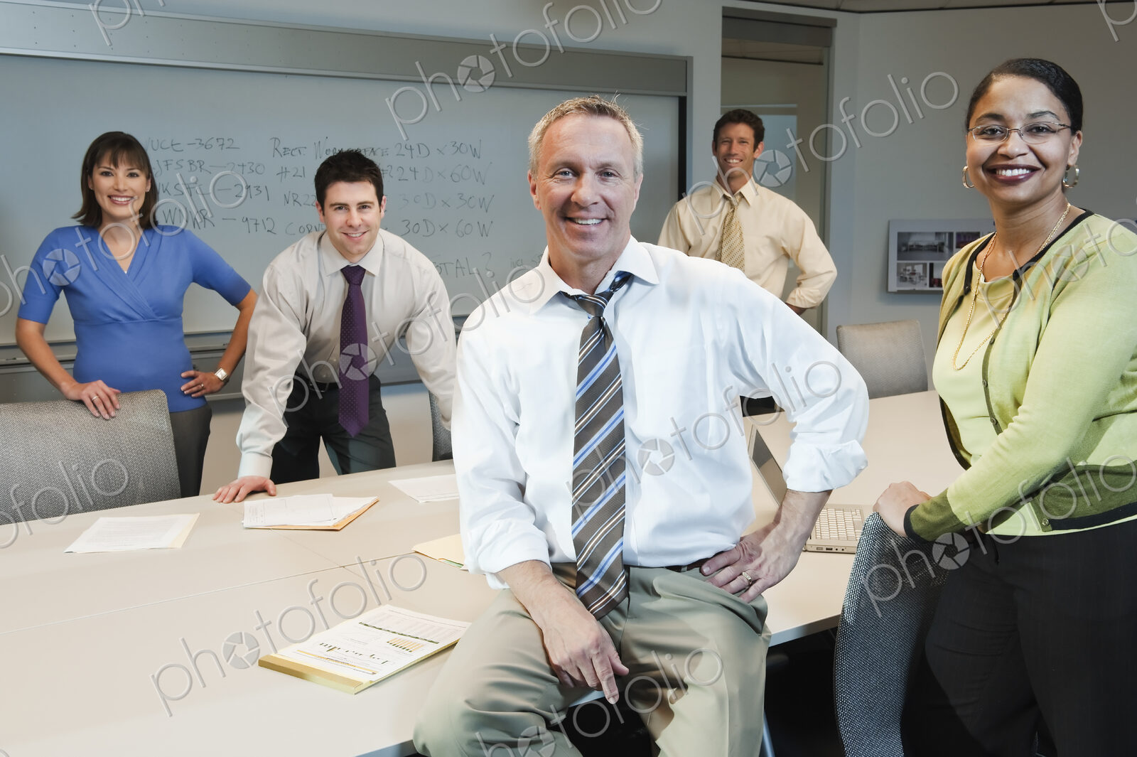 Mixed race team of business people in a conference room setting.