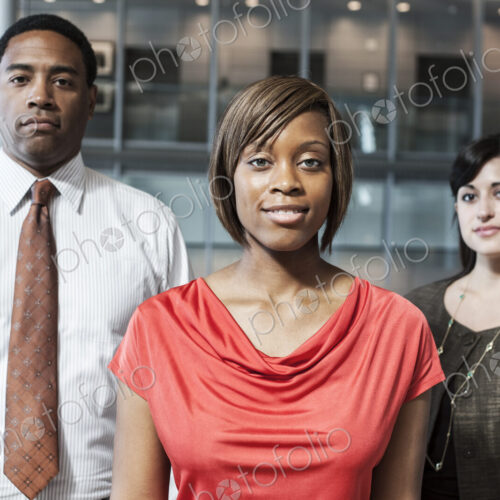 Mixed race team of business people in the lobby of a large office building. Mixed race team of business people in the lobby of a large office building.