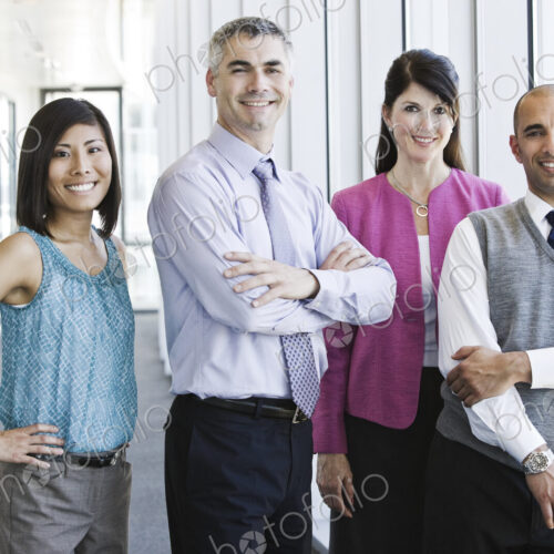 Mixed race team of business people in the lobby of a large office building.