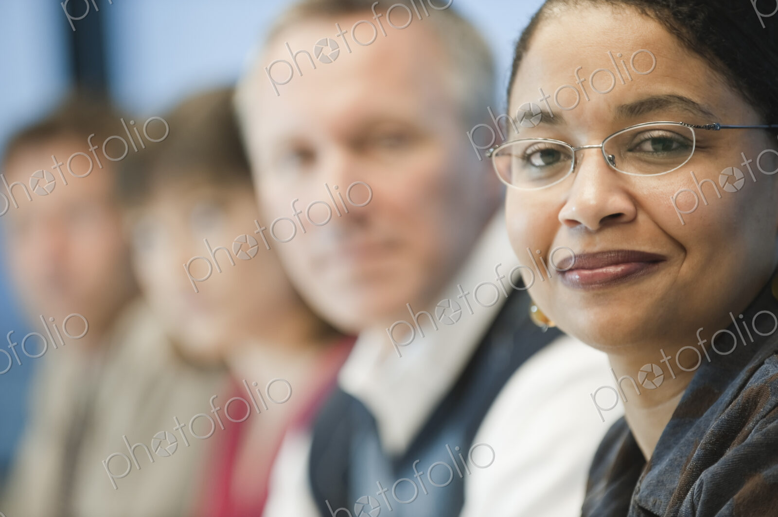 Mixed race team of business people led by a black businesswoman.