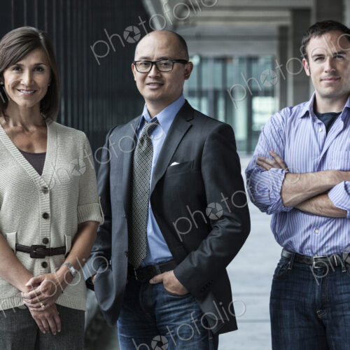 Mixed race team of business people standing in a new office space.