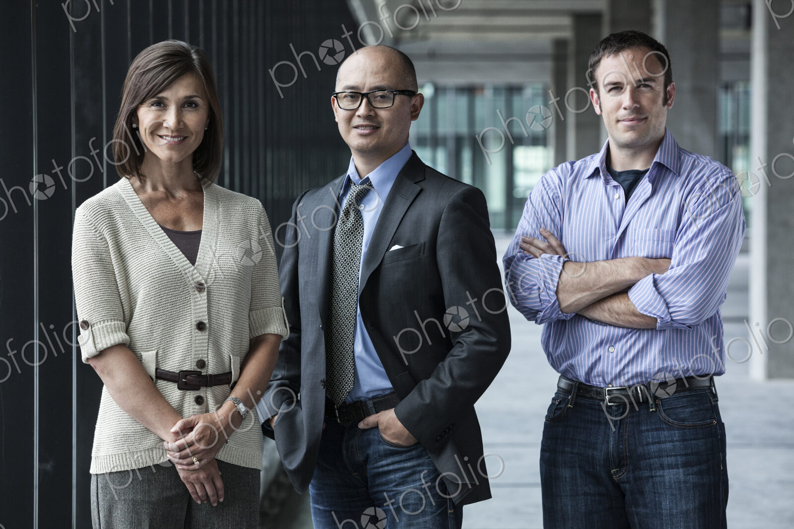Mixed race team of business people standing in a new office space.