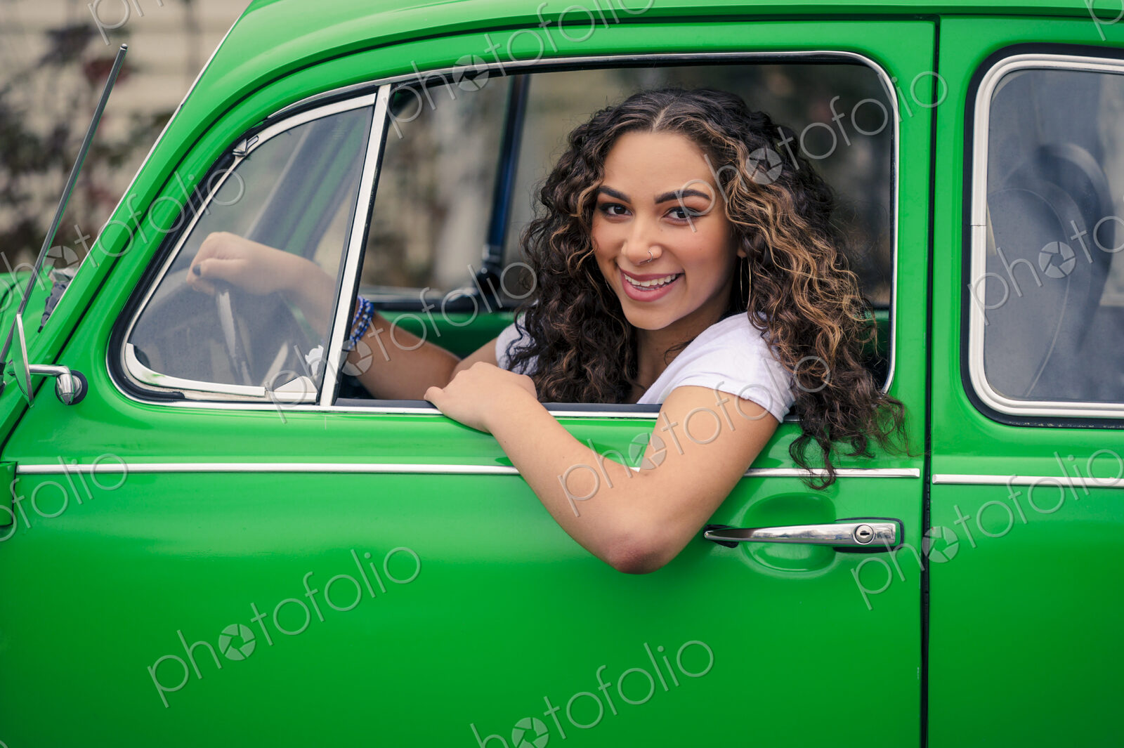 Mixed race woman driving green car