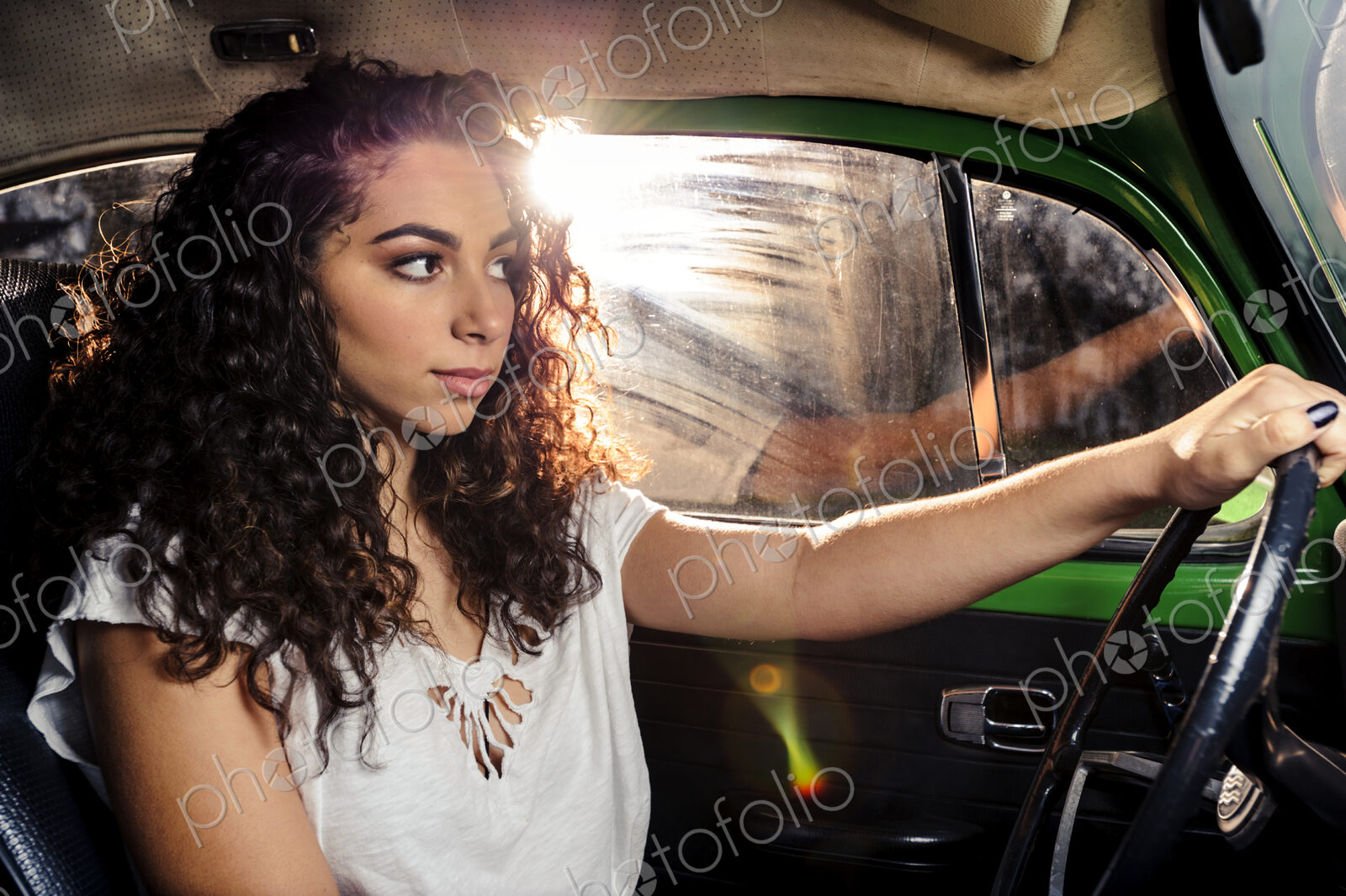Mixed race woman driving vintage car