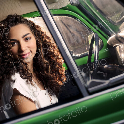 Mixed race woman driving vintage car Mixed race woman driving vintage car