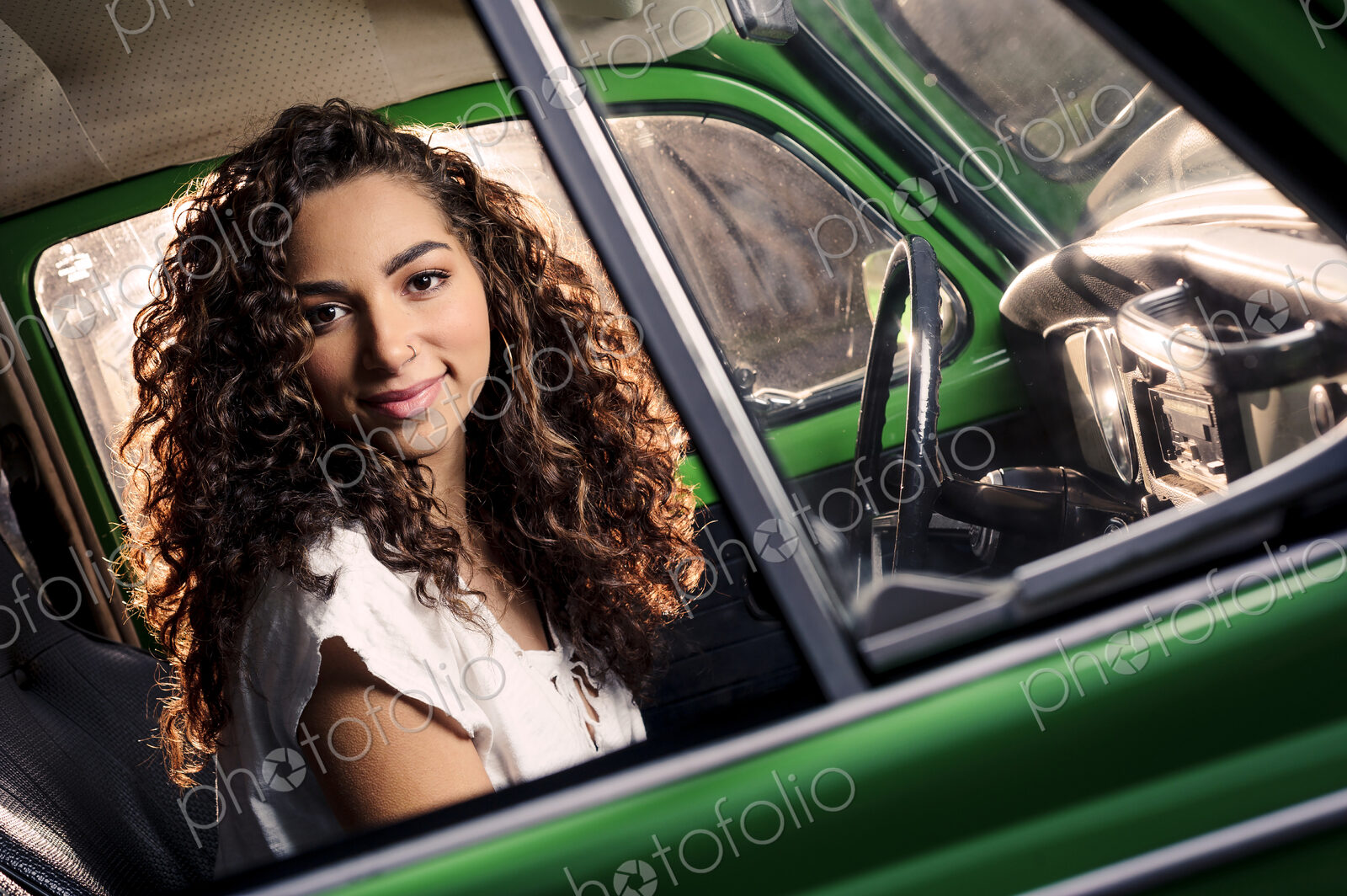 Mixed race woman driving vintage car