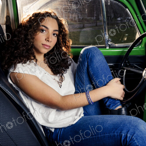 Mixed race woman sitting in car Mixed race woman sitting in car