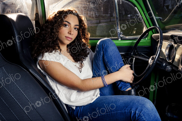 Mixed race woman sitting in car