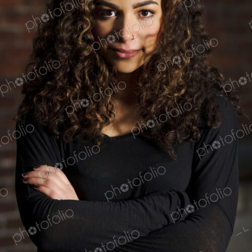 Mixed race woman standing with arms crossed Mixed race woman standing with arms crossed
