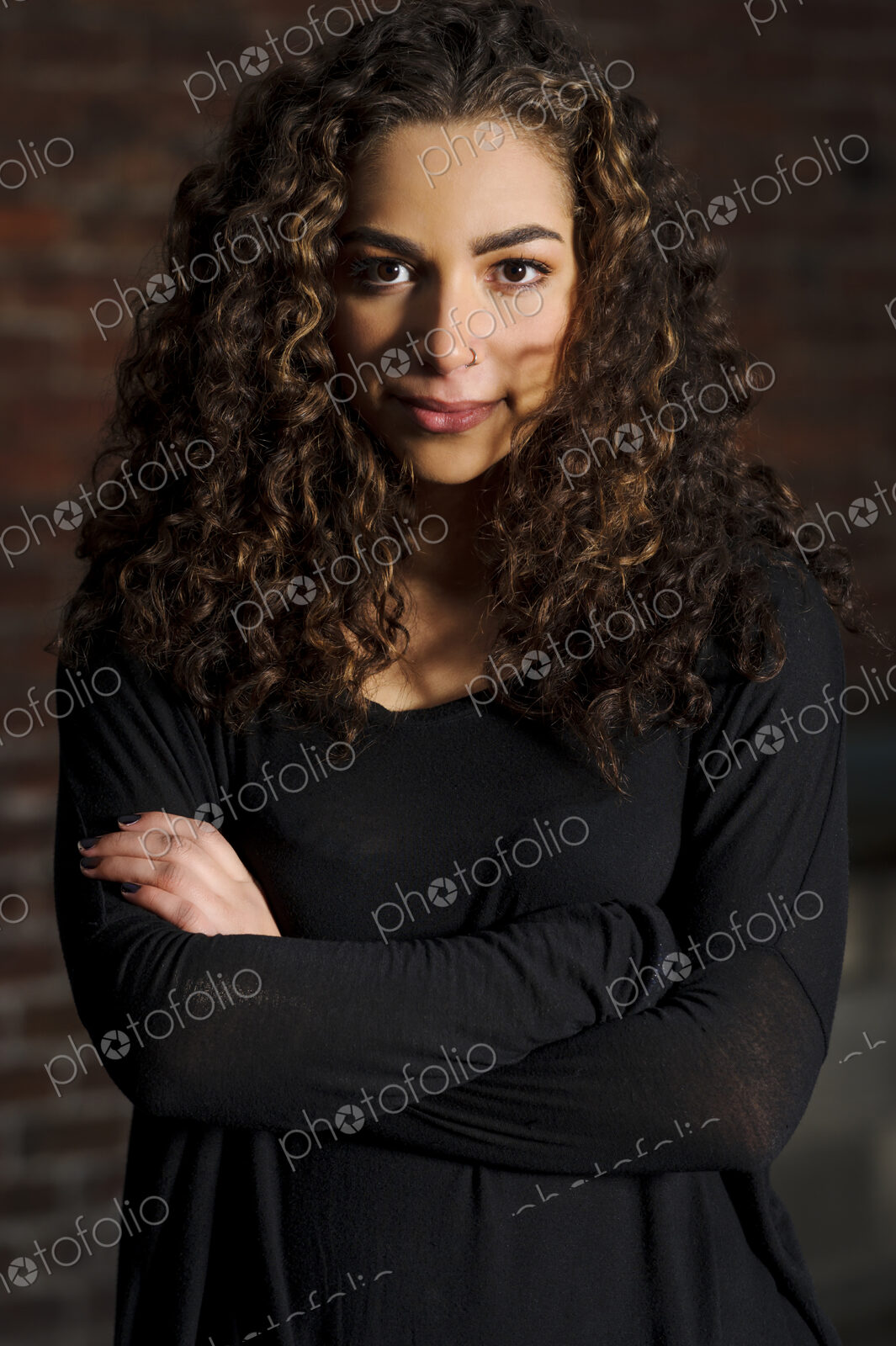 Mixed race woman standing with arms crossed