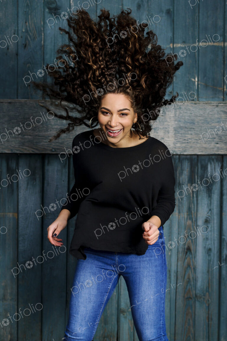 Mixed race woman tossing her hair