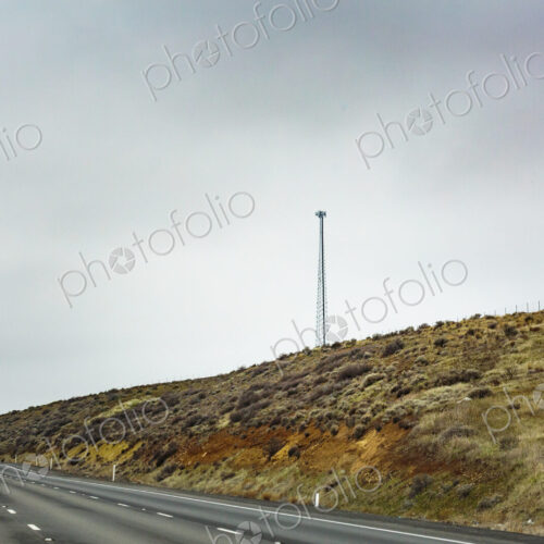 Mobile phone tower in rural desert landscape above Interstate 90 Mobile phone tower in rural desert landscape above Interstate 90