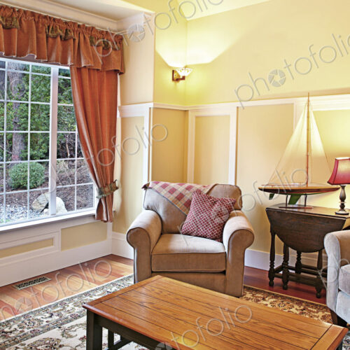 Model sailboat in livingroom with armchairs Model sailboat in livingroom with armchairs