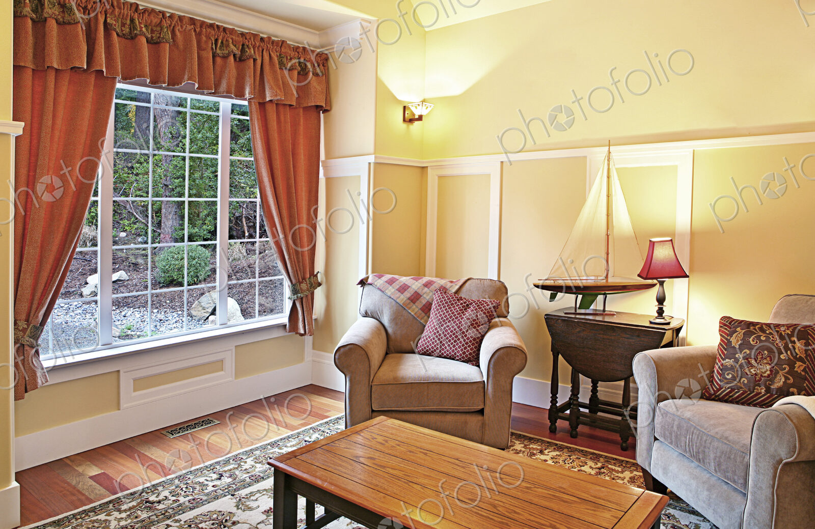 Model sailboat in livingroom with armchairs