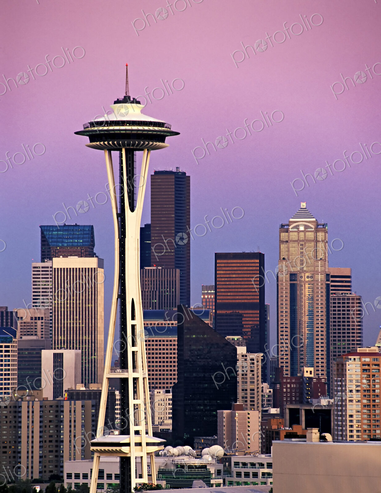 Modern Seattle skyline at sunset, including space needle and skyscrapers.