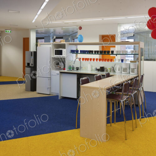 Modern college building, red balloons on a pillar, blue and yellow flooring, and… Modern college building, red balloons on a pillar, blue and yellow flooring, and…