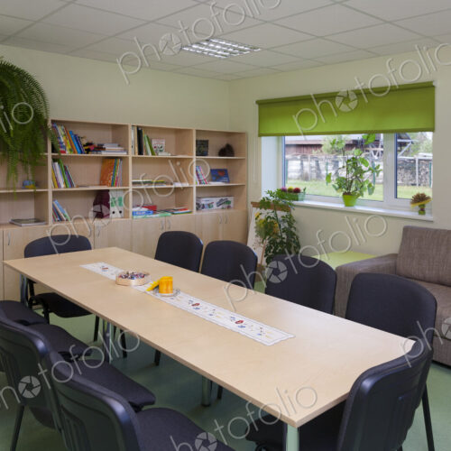 Modern day care nursery or pre-school, spacious interiors, room with tables and chairs Modern day care nursery or pre-school, spacious interiors, room with tables and chairs