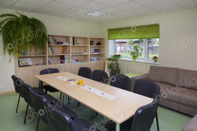 Modern day care nursery or pre-school, spacious interiors, room with tables and chairs