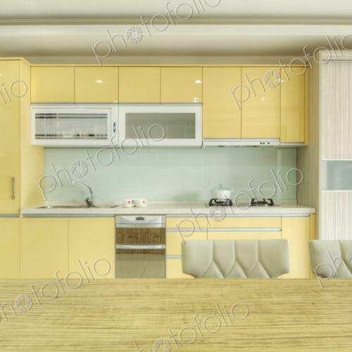 Modern kitchen with fitted cupboard, sink, kitchen ventilator and oven.