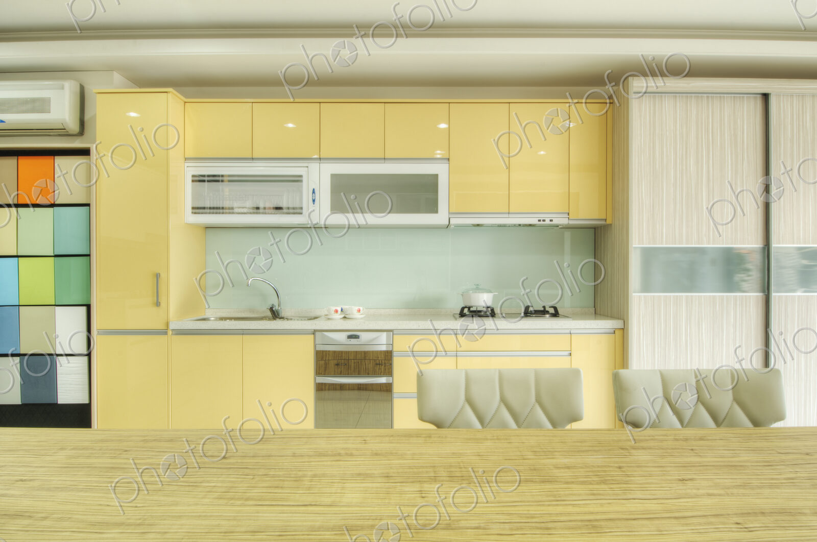 Modern kitchen with fitted cupboard, sink, kitchen ventilator and oven.