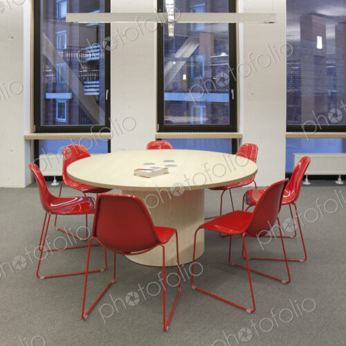 Modern meeting area in a building, college or office, round table and chairs.