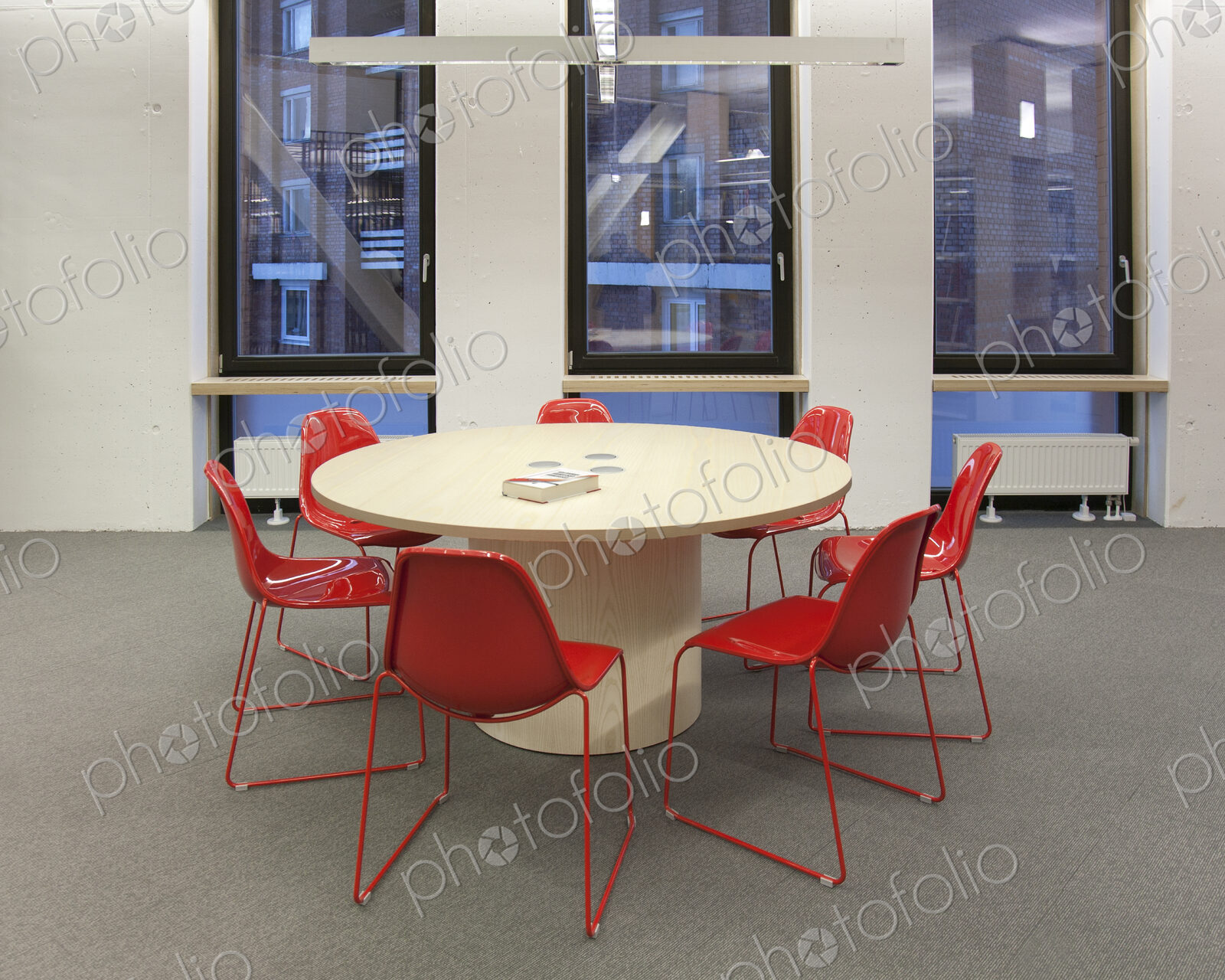 Modern meeting area in a building, college or office, round table and chairs.
