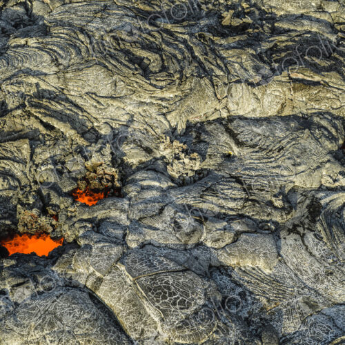 Molten lava glowing near dried lava Molten lava glowing near dried lava