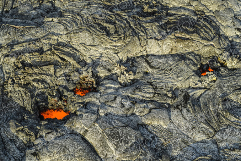 Molten lava glowing near dried lava