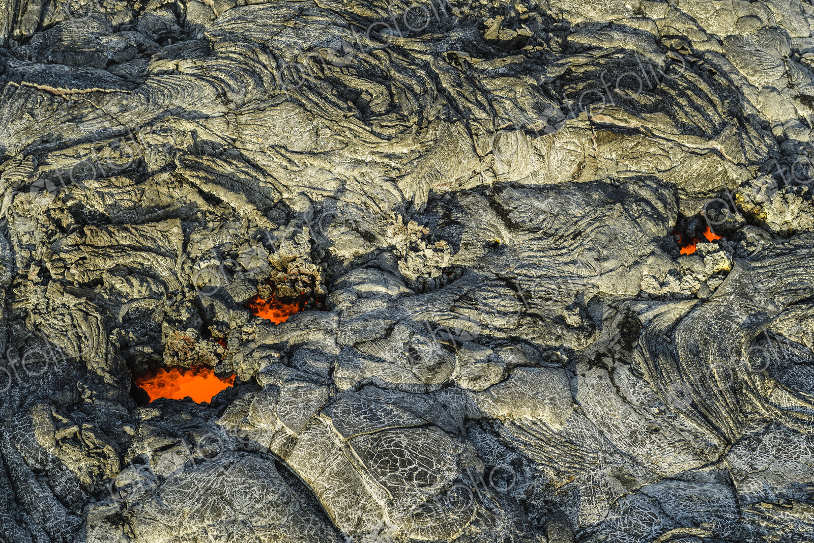 Molten lava glowing near dried lava